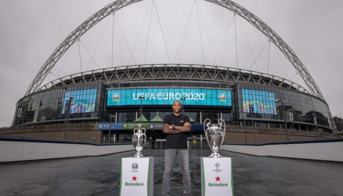 Henry with EURO and UCL Trophy with Wembley arch backdrop 2