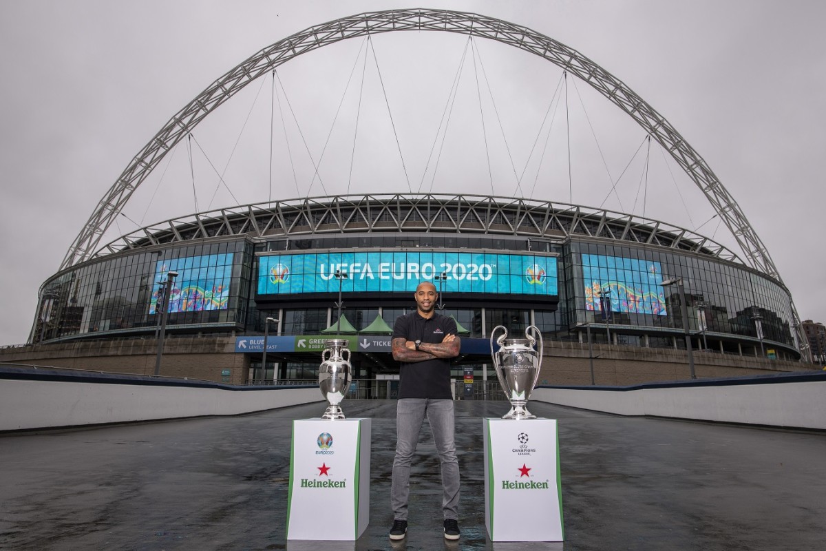 Henry with EURO and UCL Trophy with Wembley arch backdrop 2